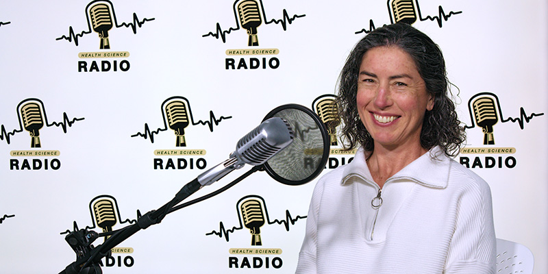 Jennifer Stevens-Lapsley, PT, professor of physical therapy at the CU School of Medicine, sits at the microphone for an episode of Health Science Radio. 